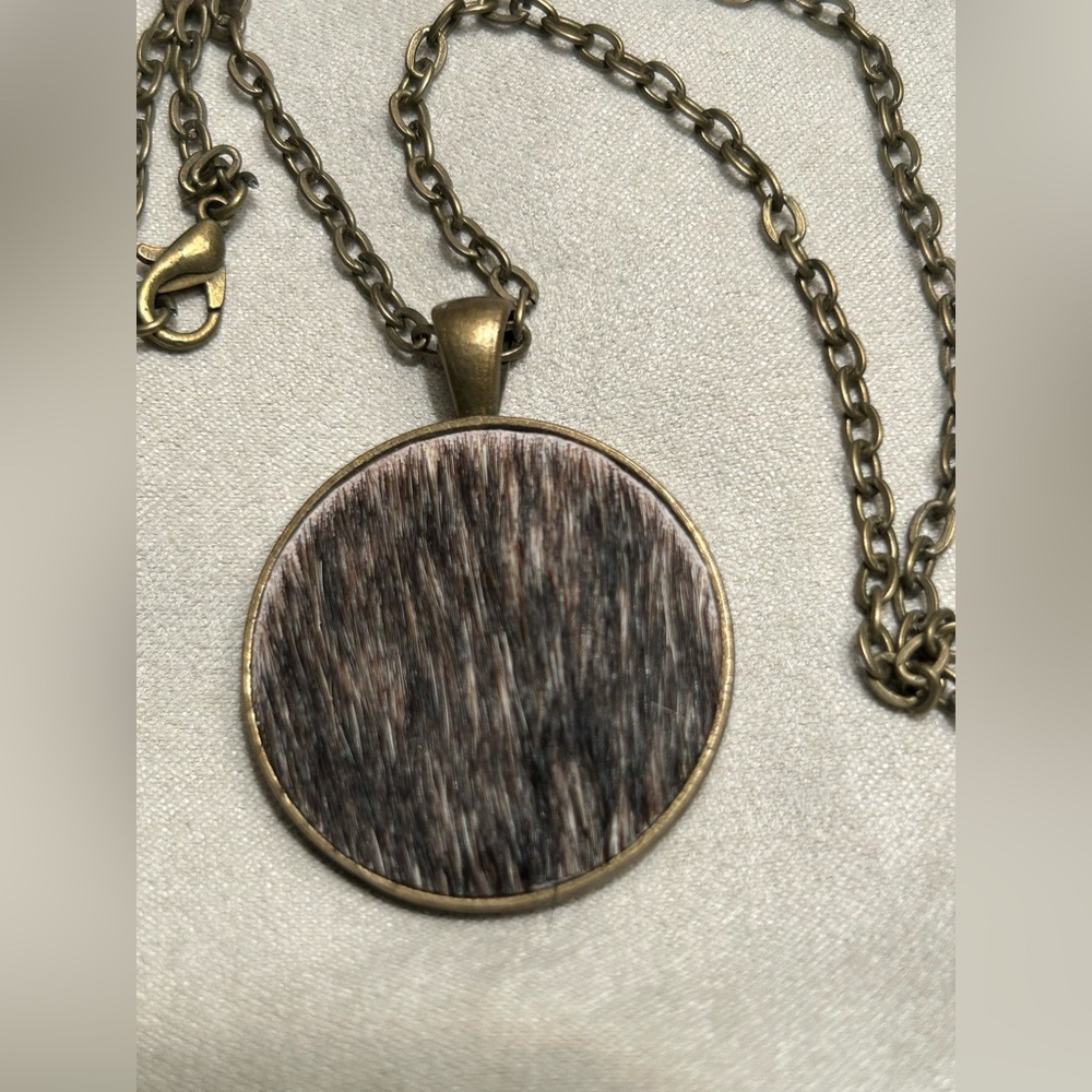 Bronze metal necklace with cowhide pendant